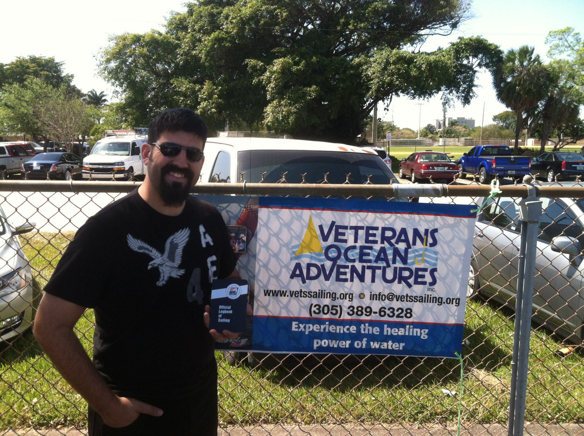 A man holding a sailboat certification book.